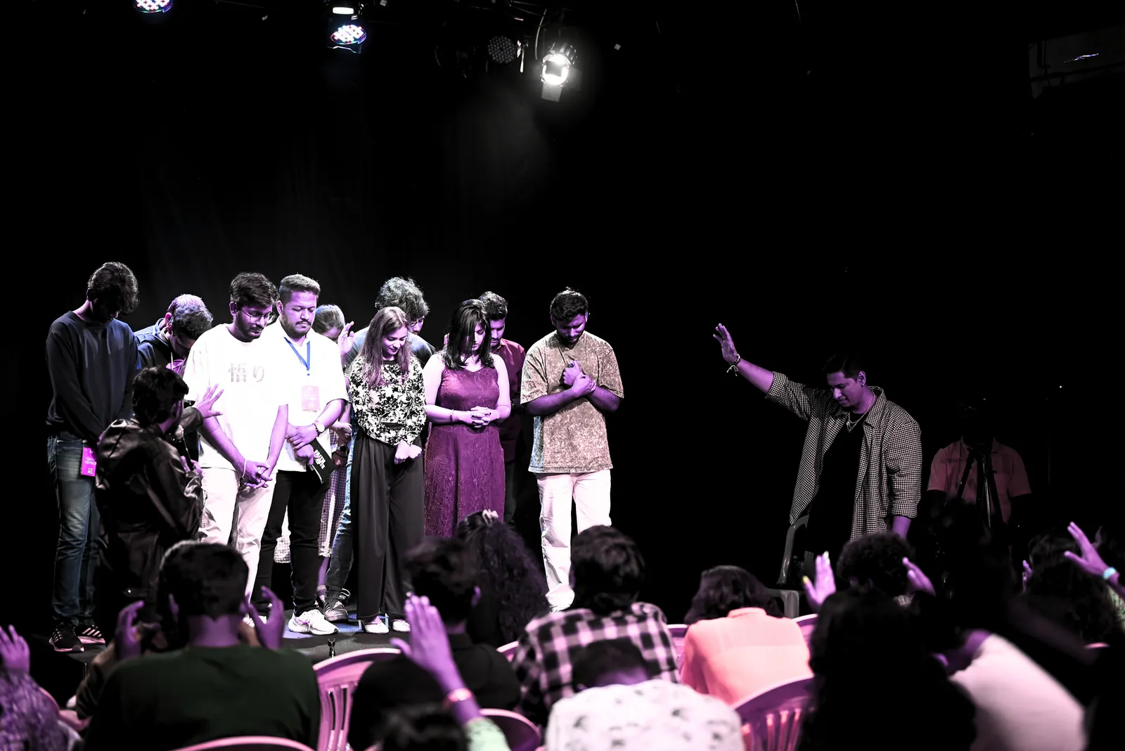 The whole room on stage together at the end of a Faith Unmute night