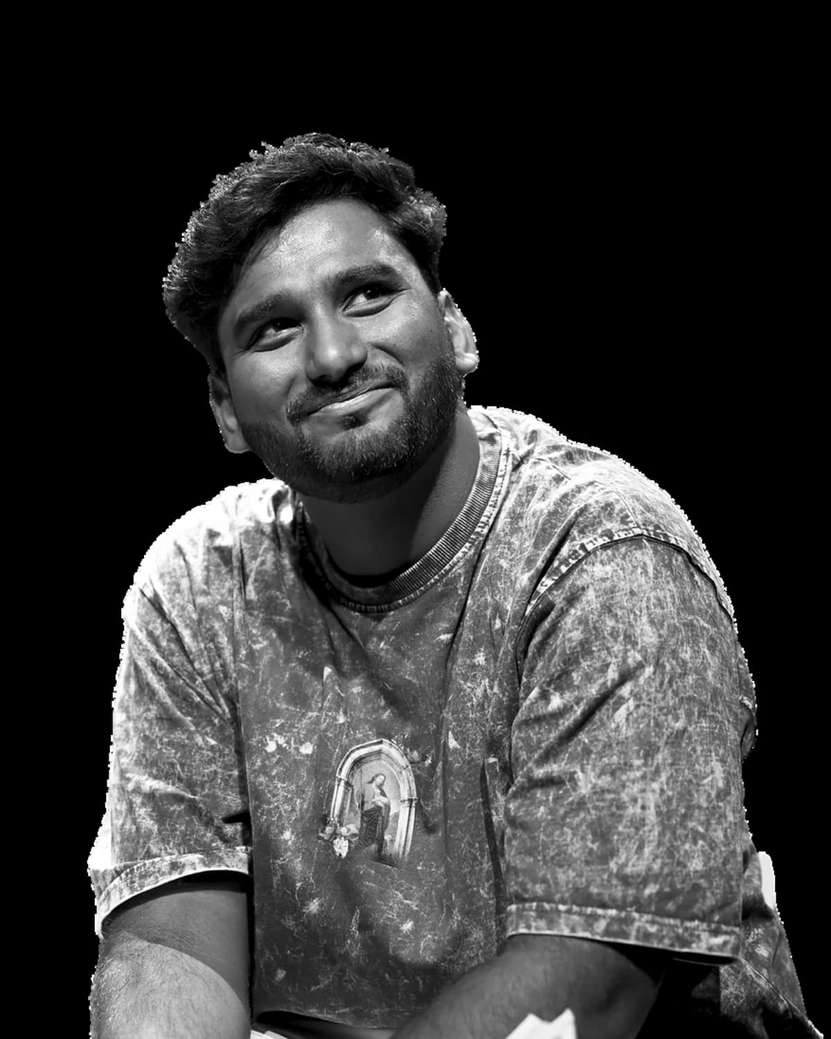A Faith Unmute host on stage, mid-laugh under the lights